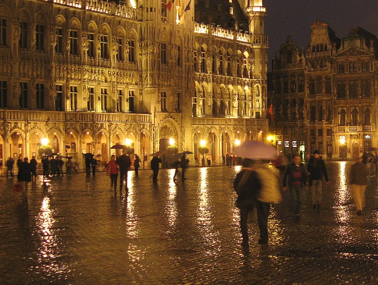 a group of people walking down the street in front of a building