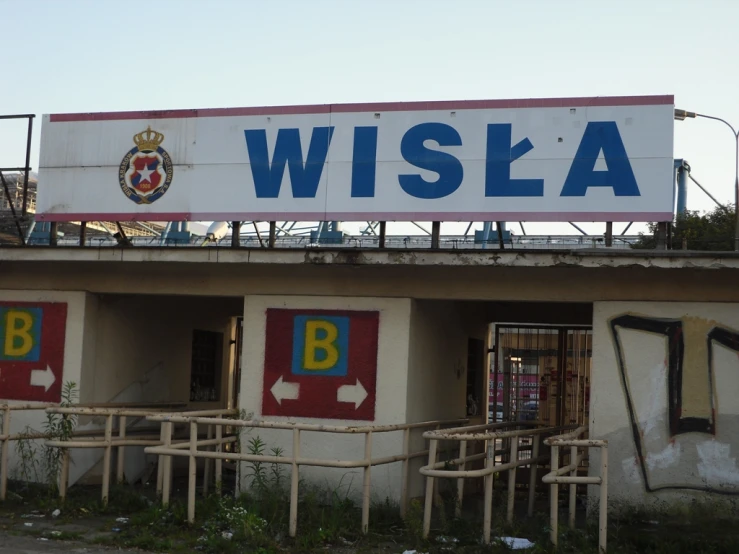 a sign that is above a building that says wisha