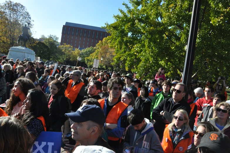 a large crowd of people walking down a street