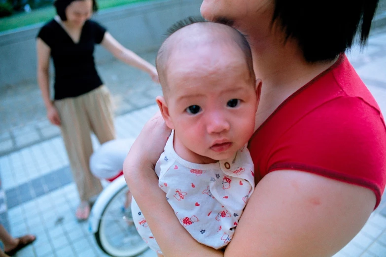 an adult woman holding a baby in her arms