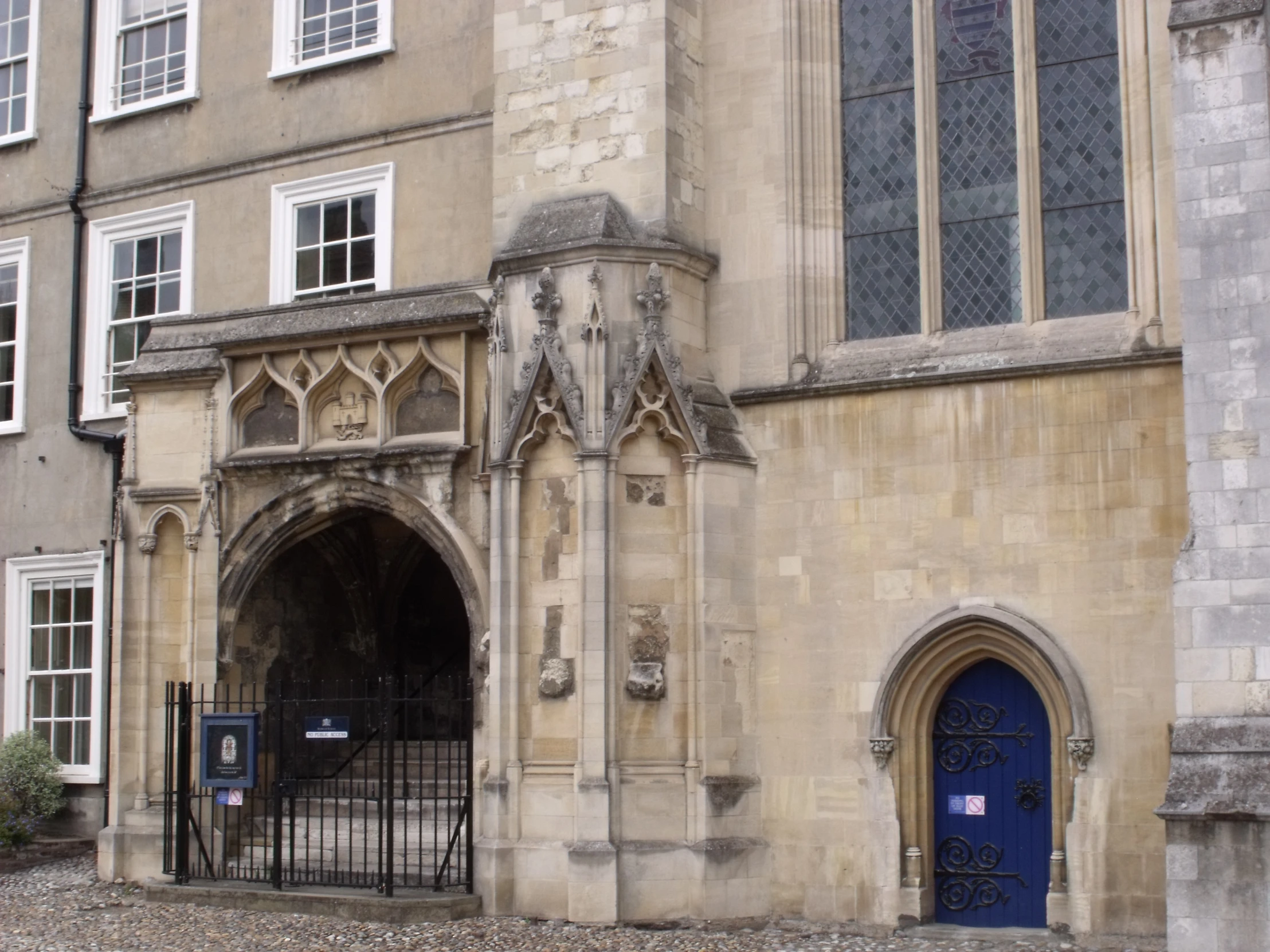 old building with wrought iron railing next to the entrance