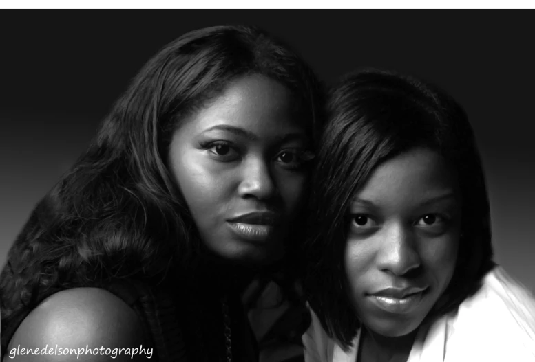 two woman looking into the camera and one is black and white