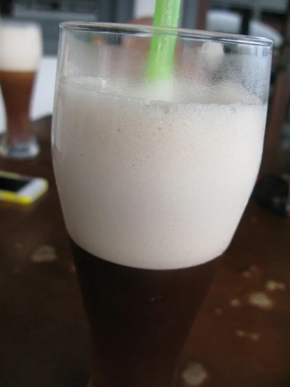 a close up of a drink in a glass with a straw