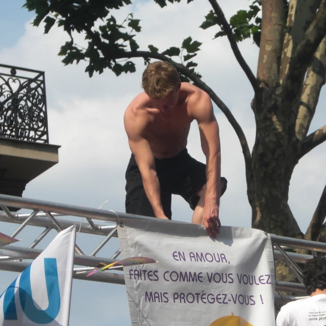 a man is standing on the ledge of a balcony