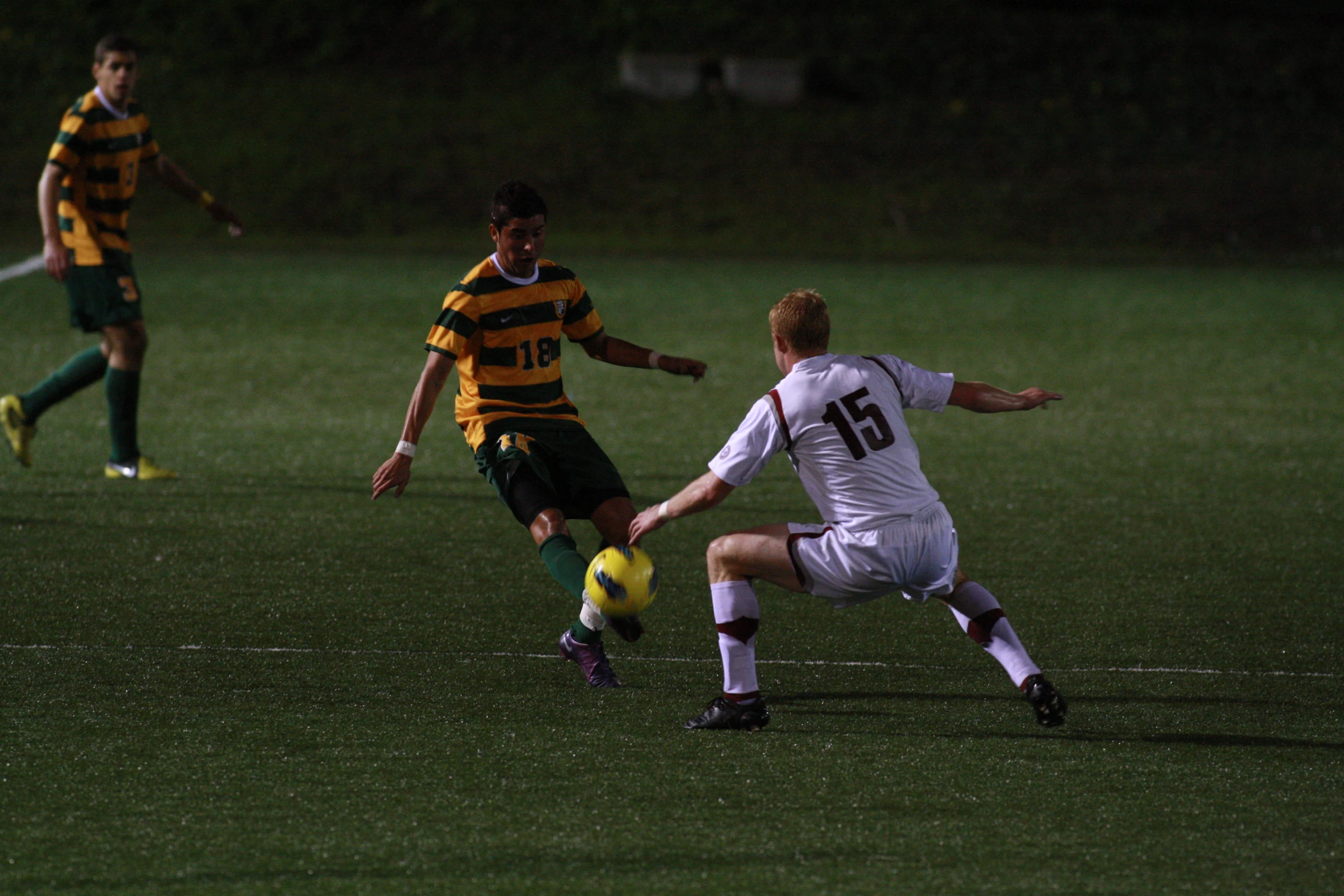 a soccer player tries to get the ball away from another player