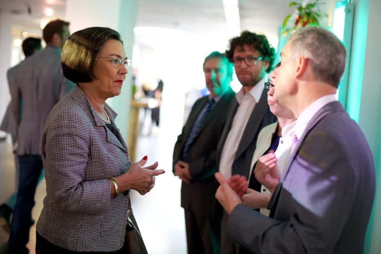 two men and a woman standing in front of another man