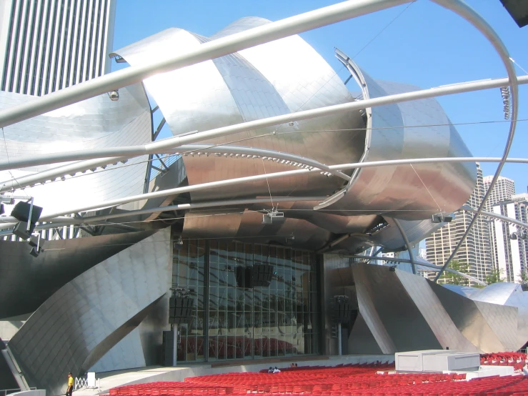 a building with metal walls, an iron gate and a big red seat