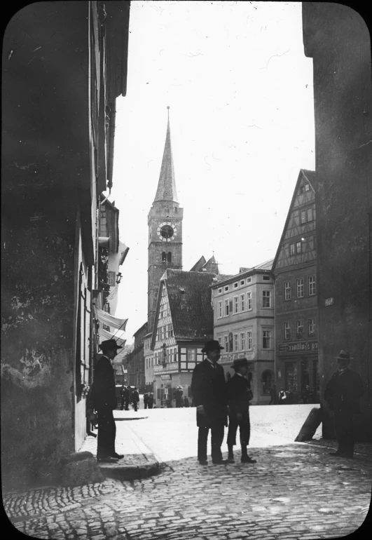 black and white pograph of men standing on a street corner