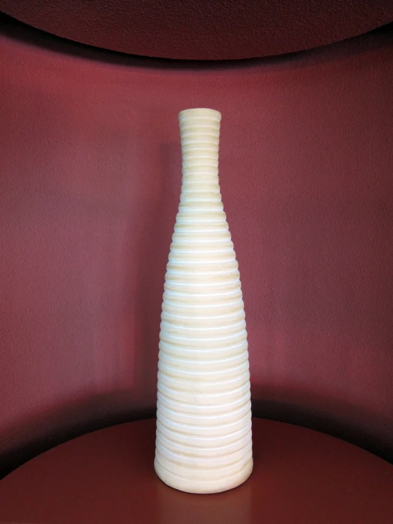 a large white vase sitting on top of a table