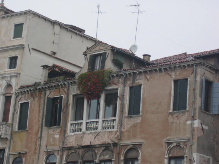 some tall buildings next to each other and one has a balcony