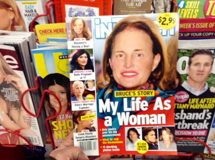 magazines stacked together and a woman with red glasses