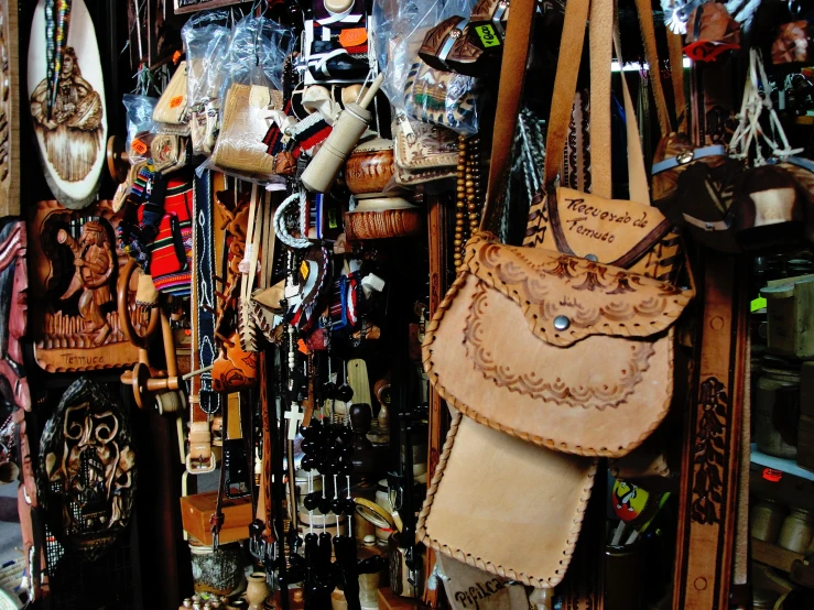 a wall full of various hats, celets and purses