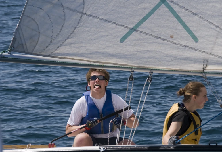 a man on a sail boat with his face open