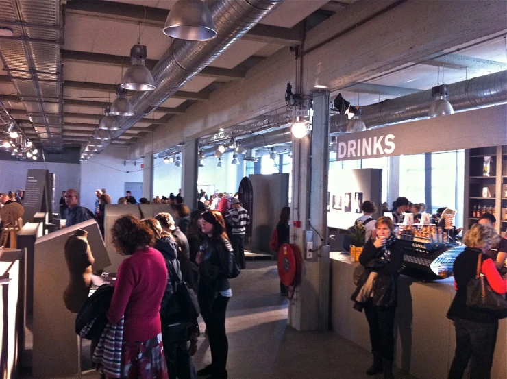 a group of people standing around in an office space