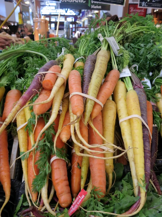 several bunches of carrots sitting next to each other