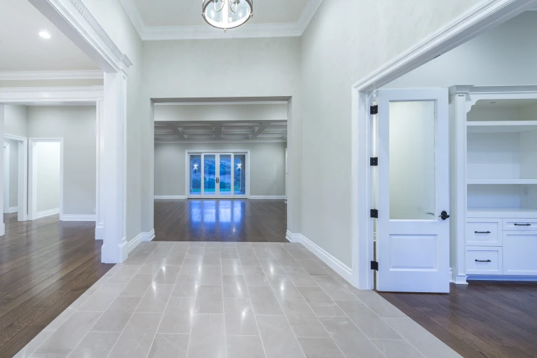 an empty room with hardwood floors and a clock