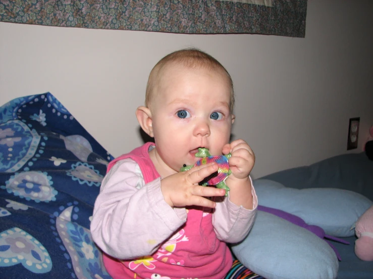 a young baby plays with a toy