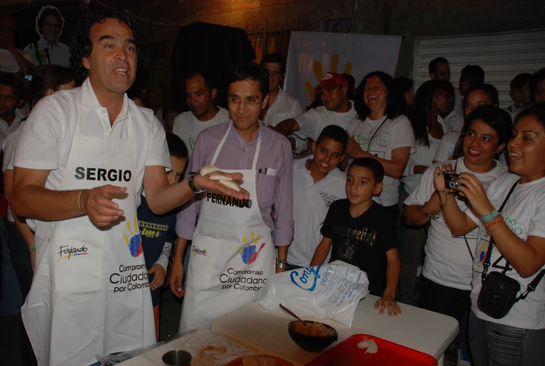 group of people gathered around the same person  food