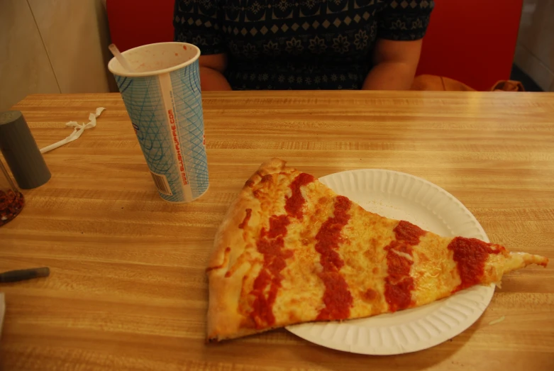 two slices of pizza on a white plate with one slice missing