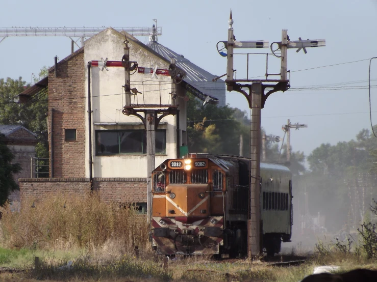 a train passing by an old run down building