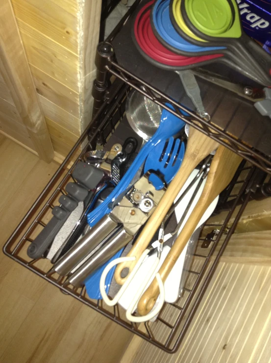 a shelf holding utensils and a pile of wood