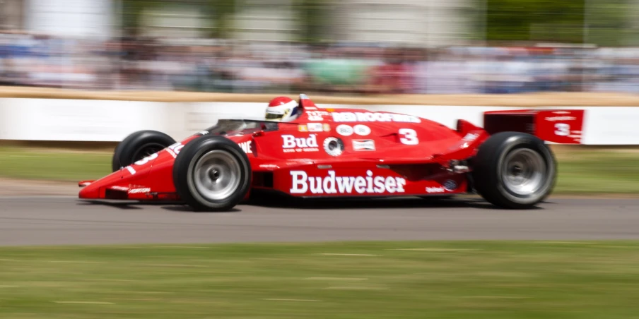 a racing car with people watching from the stands