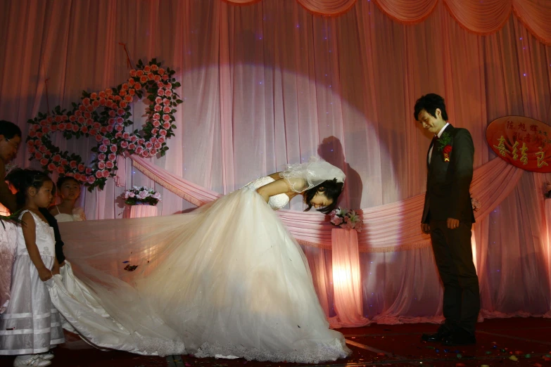 a bride and groom perform a traditional korean dance