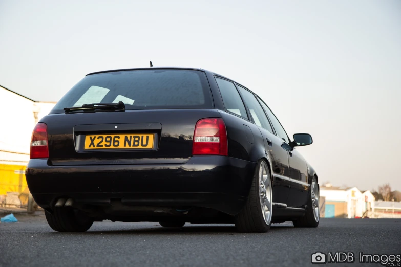 the rear view of a black bmw m5 with large windows