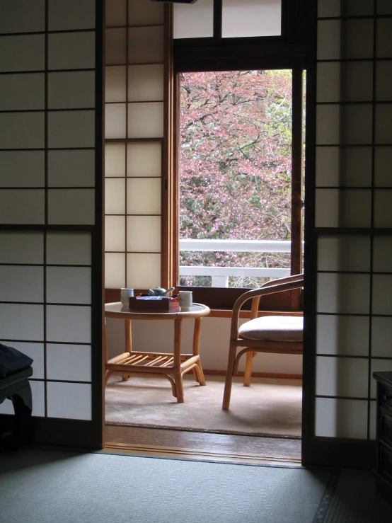 a room is seen from a doorway with a chair next to a table