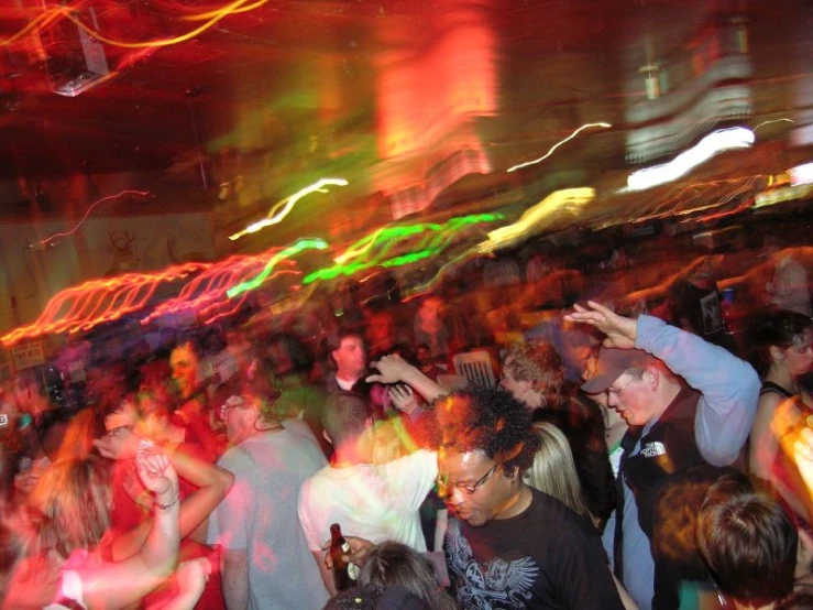 a crowd is dancing in a club at night