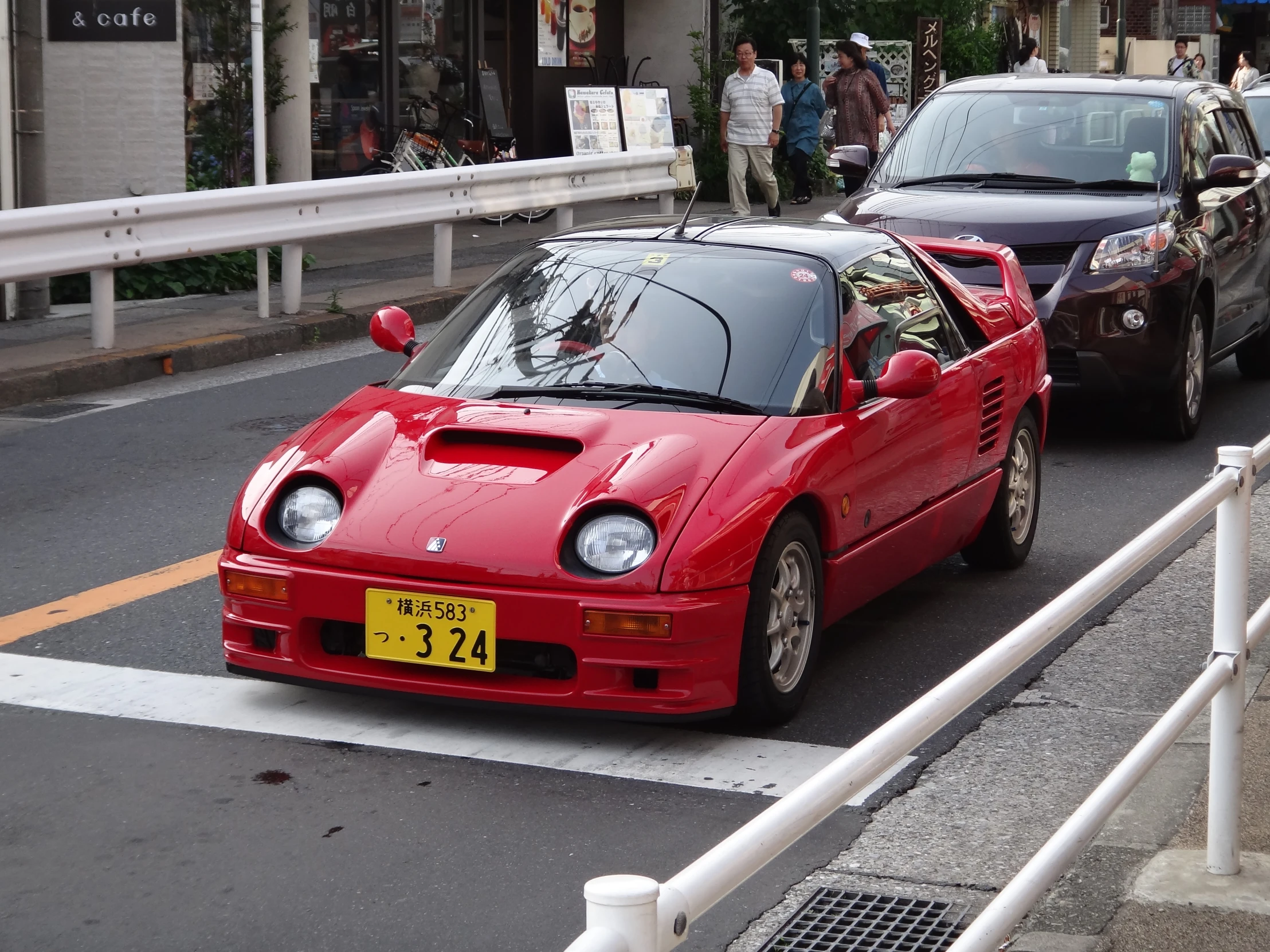 a red car is parked in a parking space