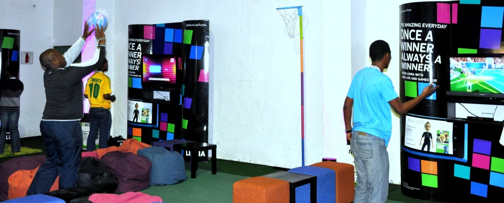 two men are trying on the television in a room