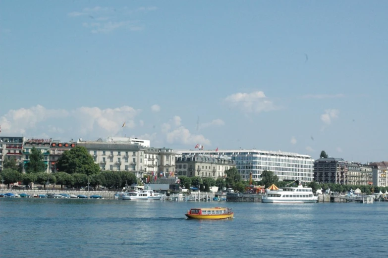 a small boat out in the water near some buildings