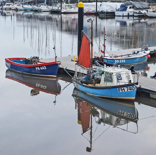 the boats are moored in the water near each other