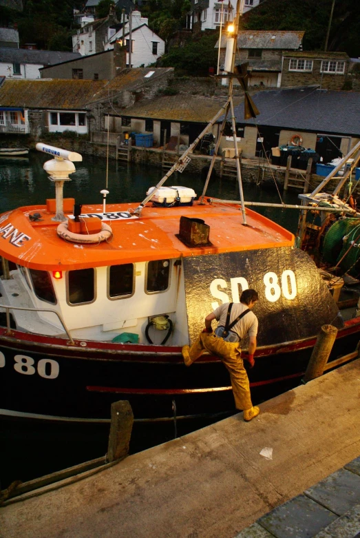 a boat docked at a pier with it's lights on