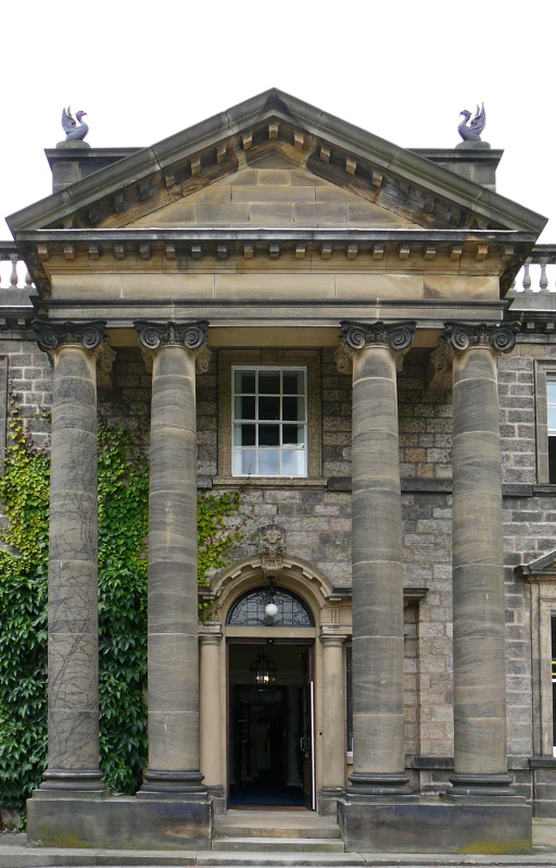 the large building has columns around the doorway