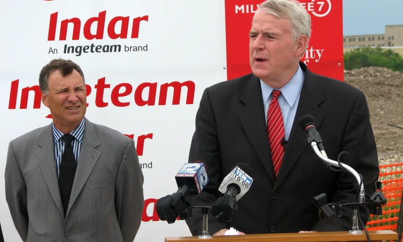 two men who are standing at a podium