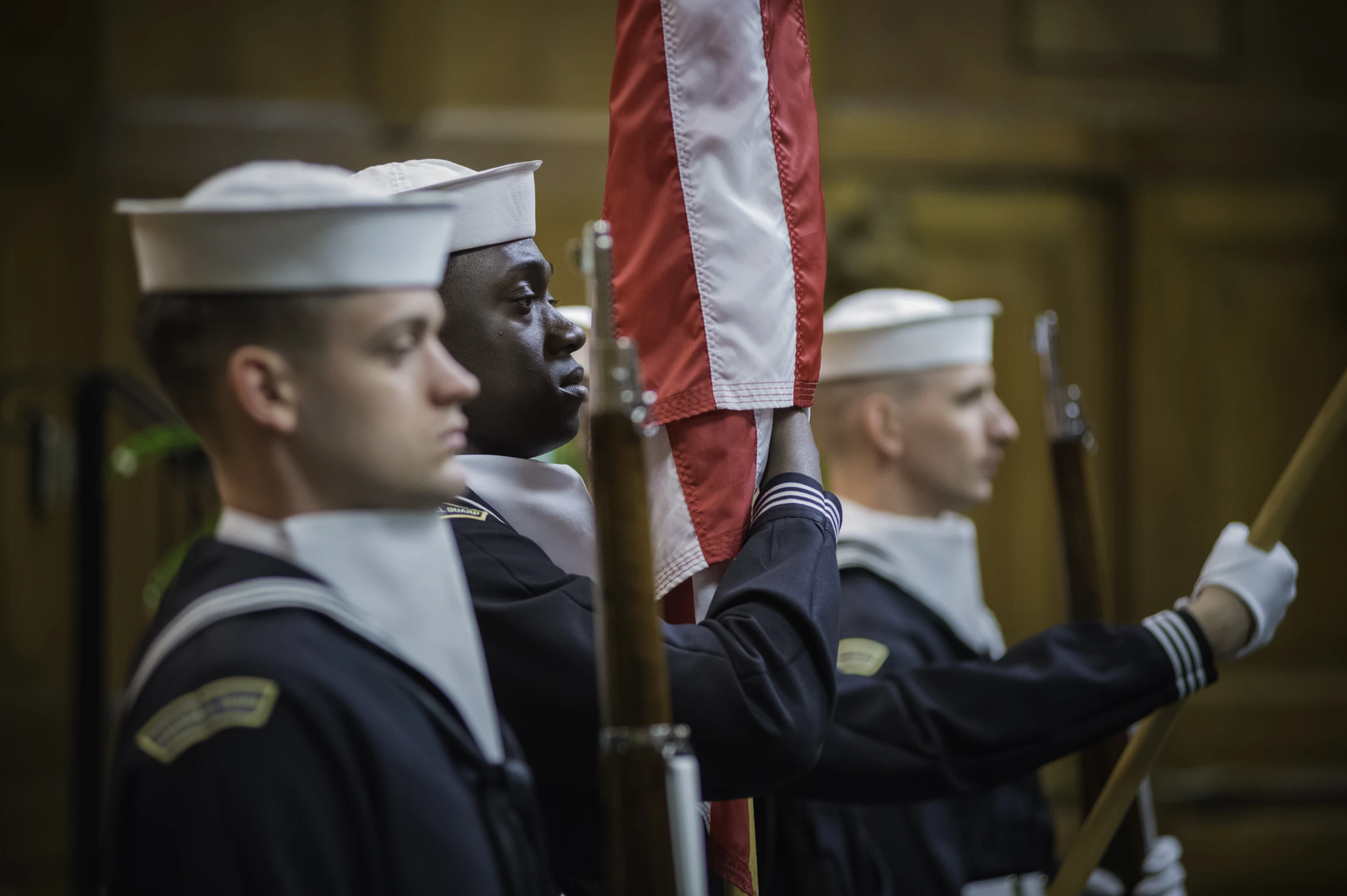 the sailors are holding the flag for a ceremony