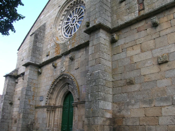 a large stone building that has a green door in it