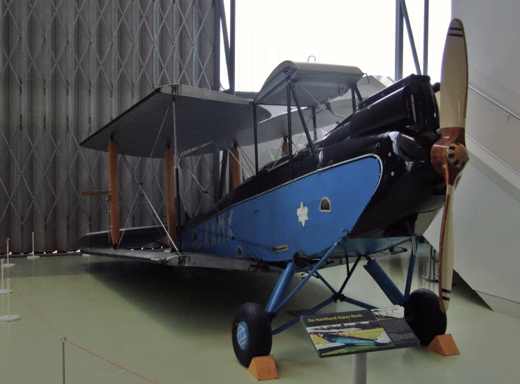 the airplane is sitting in the museum next to some glass