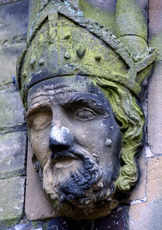 a close up of a face on the wall