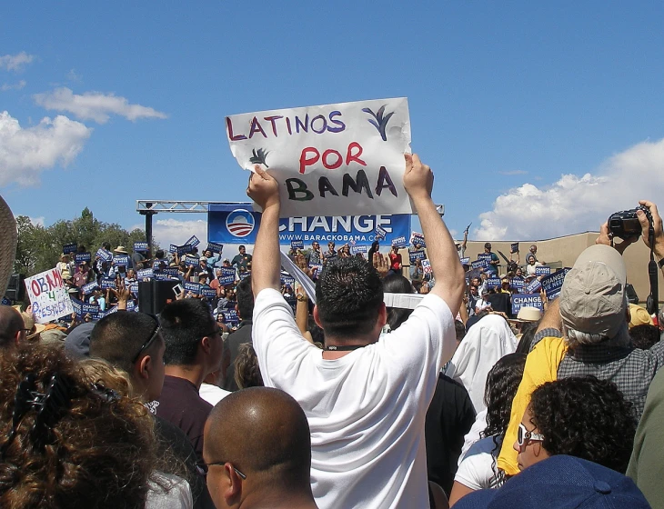 a bunch of people with some holding signs