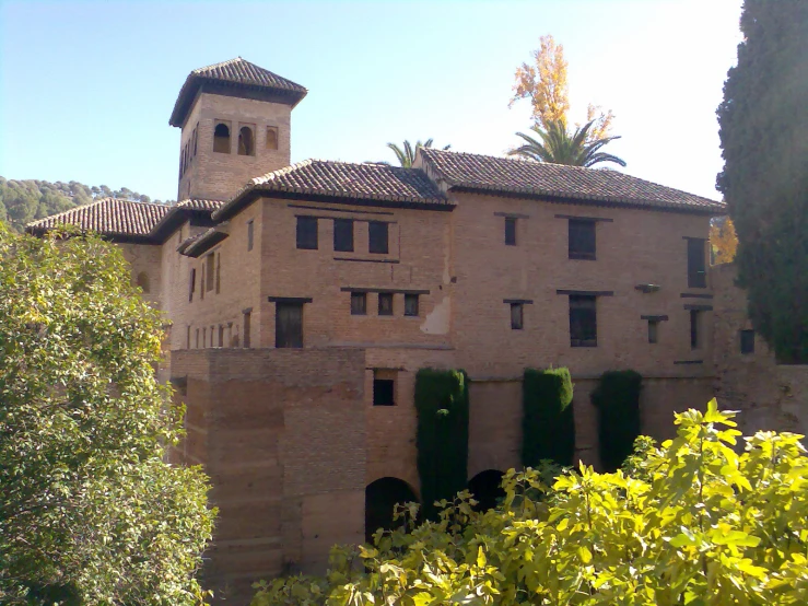 an old building with some plants growing out of it