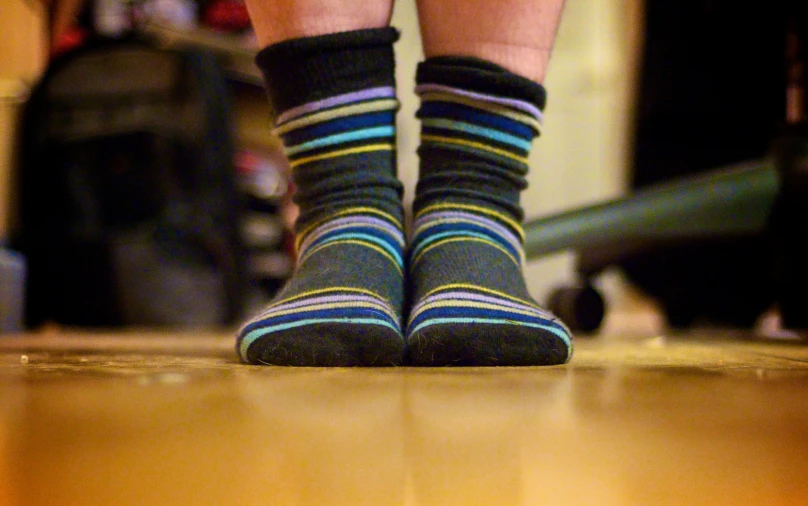 a close up po of legs in colorful socks