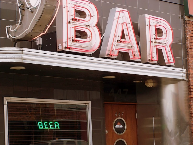 there is an illuminated sign for the bar