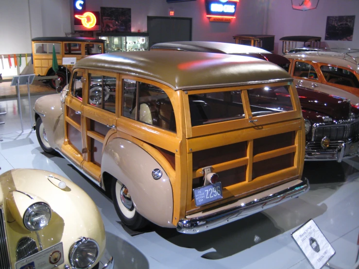 an old style bus with a flatbed on display in a museum