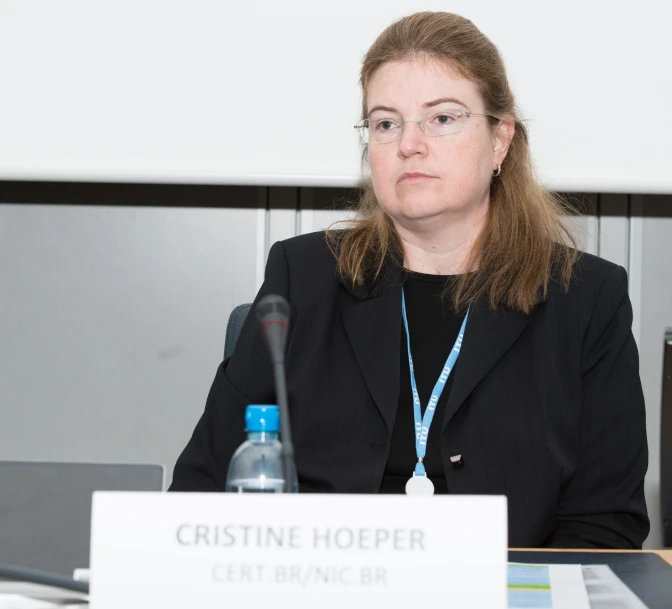 a woman sitting at a table with a microphone