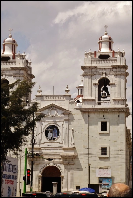 an old church with large towers next to a street