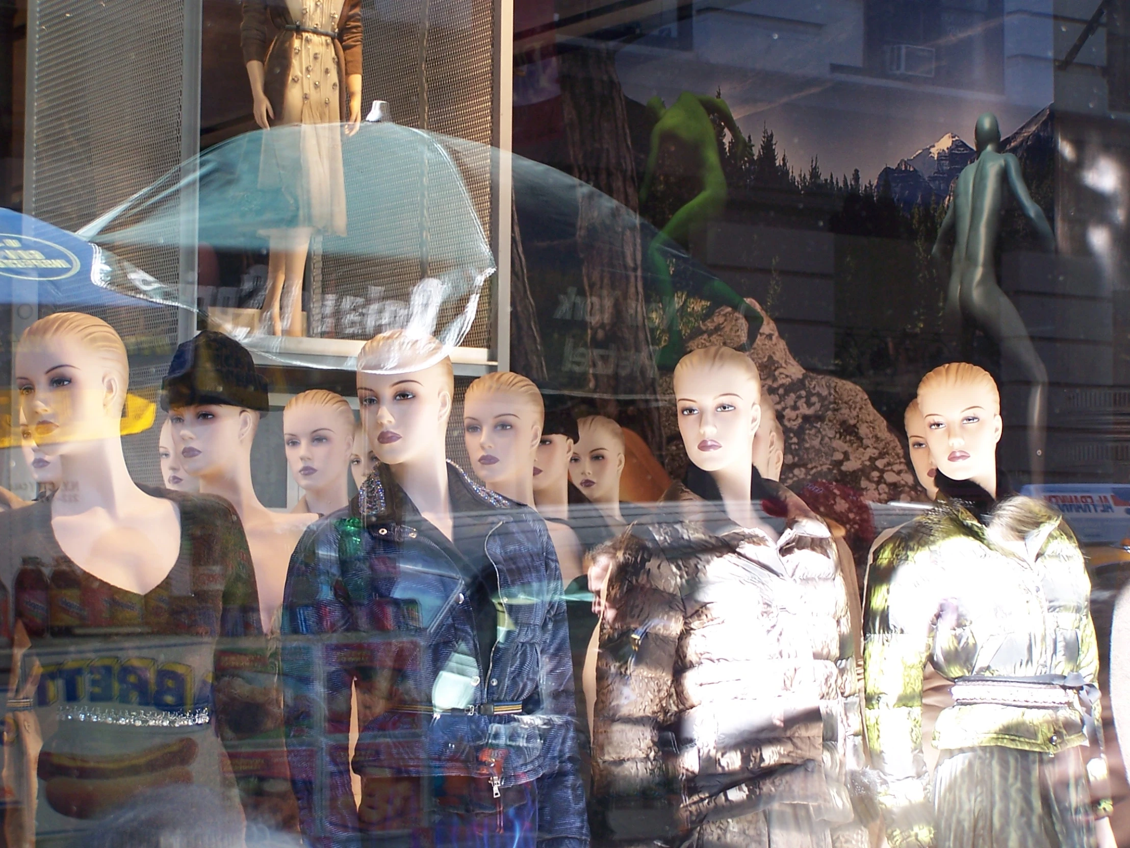 a display of mannequins in the window of a shop