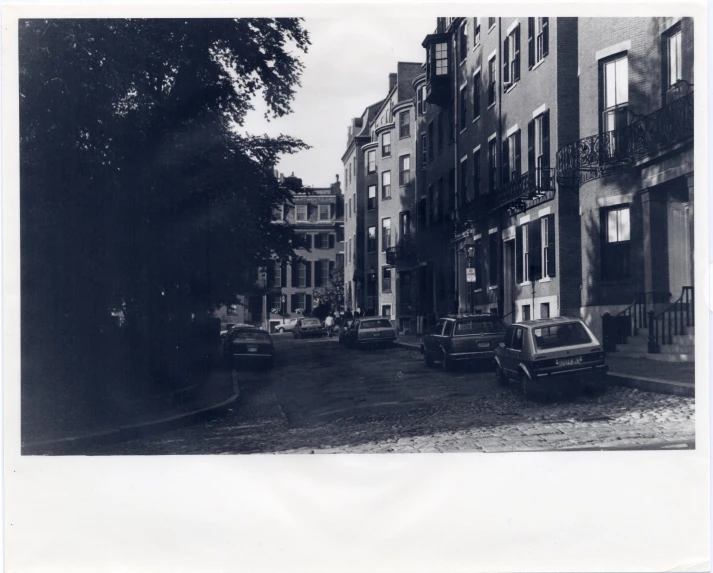 cars parked outside of buildings on a street corner